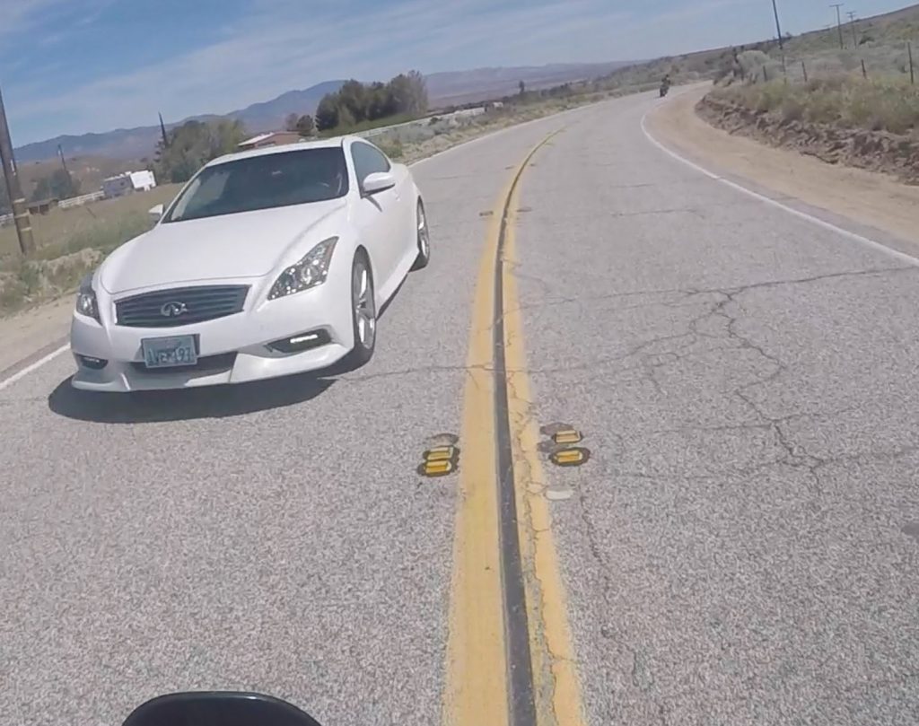 Watch The Disturbing Moment A Motorcycle ALMOST Runs Head On With Oncoming Car